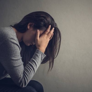 woman with head in hands