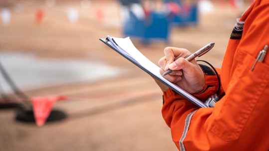 Construction worker signing document